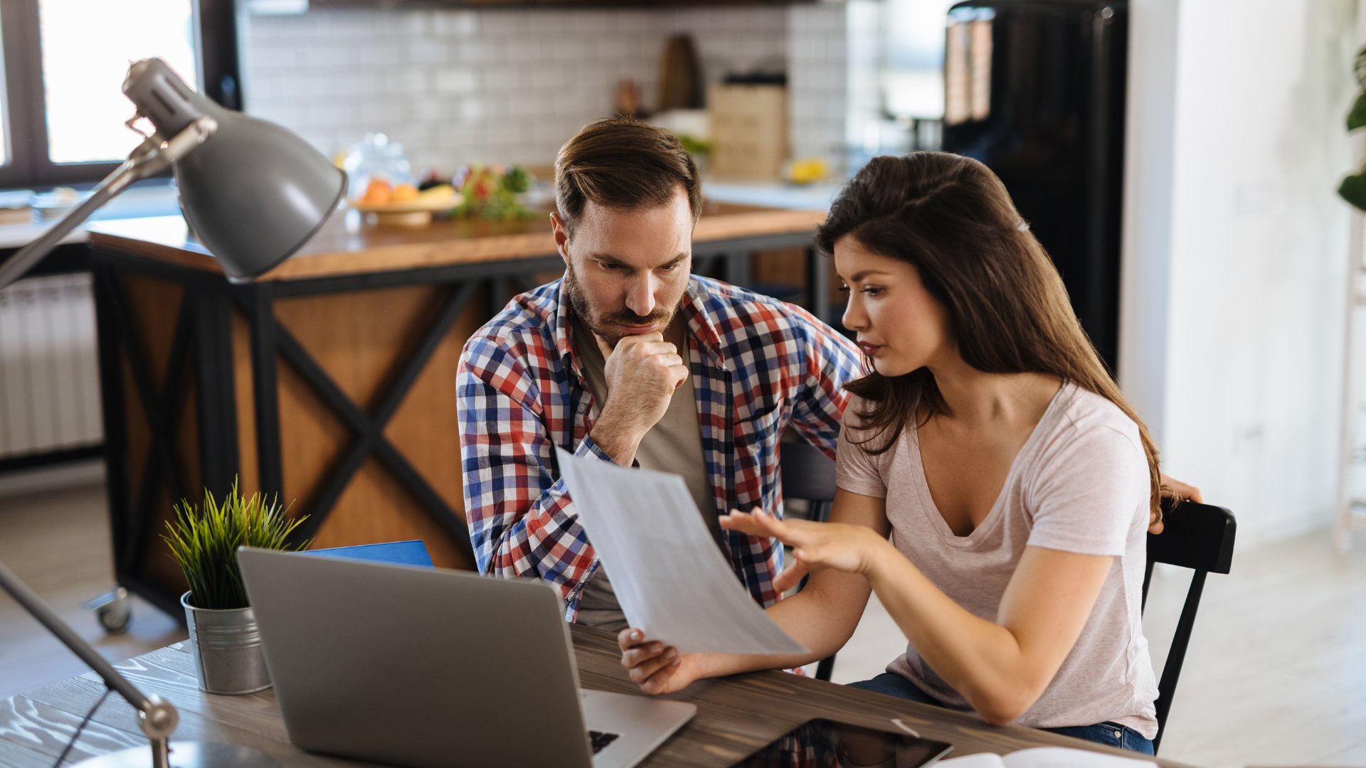 Couple reviewing mortgage documents at home